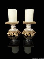 Pair of ornate Fitz and Floyd porcelain candle holders with pearl and gold detailing, square tops with textured white LED candles on top