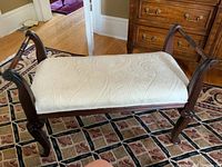 Full view of wood framed upholstered bench showing overall shape, upholstery, and wood frame