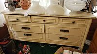 Front view of painted wood dresser with faux bamboo detailing, two top knobs and two bottom bail pulls
