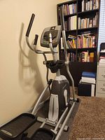Front angled view of the Horizon EX-59 elliptical machine showing pedals, handles, and digital display.