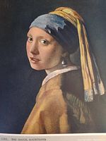 Color print of 'Girl with a Pearl Earring' by Johannes Vermeer showing the woman with headscarf and pearl earring.