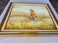 Frontal photo of the framed original painting showing a girl picking daisies in a grassy field, highlighting the piece's condition and framing.