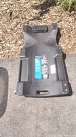 Top view of the black resin mechanic's creeper showing padded headrest and molded compartments