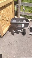 Front view of Scotts Turf Builder Pro Seeder with black hopper and two wheels