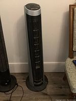 Full view of black and gray Bionaire tower fan showing overall condition and design.