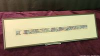 Full view of framed narrow print showing botanical garden scene with a simple frame and matting.