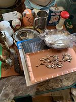 Various kitchen and decor items including salt and pepper shakers, candle holders, decorative plates and frames, and a silver plate with spoon.