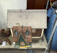 Photo showing two bird houses side by side, the smaller in front and the larger behind