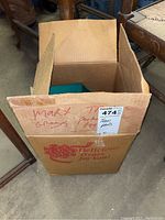 Photo of a vintage cardboard box with handwritten label 'Marx Train Parts 1947'.