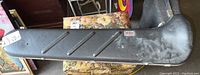 Closed black hard case of the trombone with wear evident on surface and metal latches visible.