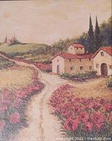 Close-up showing textured detail of the art print with countryside scene of houses and flower fields.