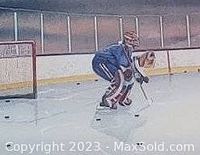 Close-up of the hockey goalie and two players on the ice, showing the details of the print.