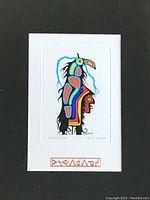 Close-up of Norval Morrisseau "Thunderbird" serigraph print mounted on white mat with decorative symbol below artwork.