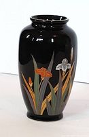 Front view of the black Otagiri bud vase showing floral and leaf designs in gold, orange, white, and green.
