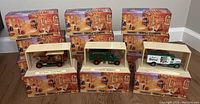 Lot of 12 Matchbox Models of Yesteryear diecast vehicles in original boxes and display cases arranged on floor