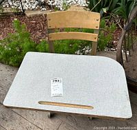 Top view of the vintage student desk showing the laminate desk surface with pencil groove and attached wooden chair.