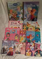 Overview of all 10 assorted Disney Princess and Frozen themed books arranged on surface with covers visible.