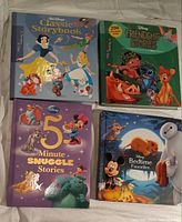 Four Disney storybooks including Classic Storybook, Friendship Stories, 5 Minute Snuggle Stories, and Bedtime Favorites.