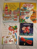 All five books laid out showing covers: three Richard Scarry hardcovers and two Eric Carle board books, one with a light-up component noted as non-working.