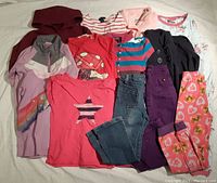 Top-down view of all clothing items laid out showing variety of colors and styles for girls size 6.