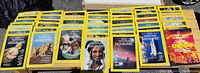 Wide layout of multiple National Geographic magazines spread in rows, mostly with yellow border covers showing various covers from 1980-1983