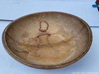 Top view of the antique wooden bowl showing interior surface and wood grain pattern with dark discolorations and signs of wear.