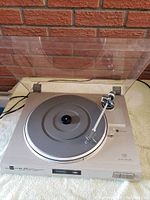 Overall view of the Dual CS 515 turntable with dust cover open, displaying the platter and tonearm.