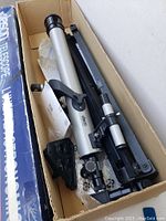 Jason telescope optical tube, tripod, and accessories inside original box from top view