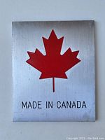 Front view of rectangular aluminum plaque with red maple leaf and text 'MADE IN CANADA'