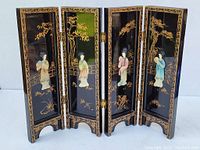 Front view of the four-panel miniature folding divider showing the detailed lacquered Asian women figures and floral decorations on a black background.