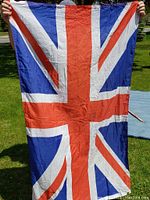 Front side of the Union Jack flag held outdoors to show color, pattern and size