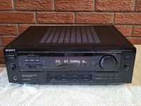 Full front view of Sony STR-DE605 receiver showing power button, display, volume knob, and input buttons.