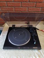 Front-angle view of Sony PS-LX430 turntable with dust cover open showing platter and tonearm.