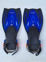 Pair of blue and black Velociter Divers adjustable swim fins shown from above, highlighting the size L-XL and adjustable straps.