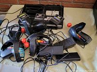 Overview photo showing the Coleco Telstar Arcade console, four joysticks with orange-red ball tops, and game cartridges.