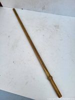 Full view of wooden practice katana lying flat showing full length and handle detail