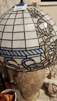 Tiffany-style stained glass shade in white and gray leaded pattern with pale blue border