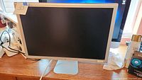 Front view of the Apple Cinema HD Display monitor showing the screen and built-in stand.