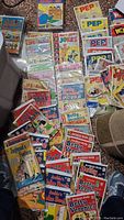 Overview of assorted comic issues laid on floor showing Life with Archie, Archie's Girls Betty & Veronica and Archie's Joke Book titles