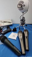 Overview of lot showing Blue Snowball, Realistic mic, handheld microphones and M-Audio interface