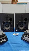 Front view of Event Tuned Reference 5 speakers with two CryBaby pedals in front.