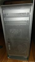 Front view of the Apple Power Mac G5 with perforated aluminum case and drive bays.