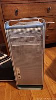 Front view of the Apple Power Mac G5 aluminum computer tower showing perforated metal case and optical drive slots.