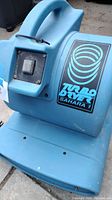 Front view of the blue Sahara 1 Turbo Dryer showing the air intake vent, power switch, and branding decal.