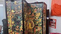 View of the front side of the four-panel room divider showing detailed continuous painted scene in multiple colors including figures and animals.