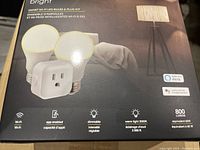 Box front showing two LED bulbs and one smart plug, with product features including Wi-Fi, app enabled, dimmable, warm light 3000K, 800 lumens, Alexa and Google Assistant compatibility.