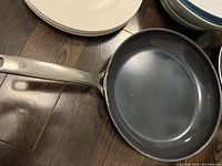 Close-up of Blue Diamond Tramontina frying pan with metal handle, showing non-stick interior and minor usage marks.