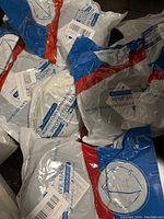 Plastic packaging of individual KN95 masks showing branding and protection details.