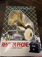 Full packaged view of the Rhythm Phone Musical Jewel Box showing front packaging and branding.