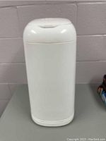 Full frontal view of white Diaper Genie diaper disposal system showing overall shape and size.